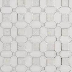 a white tiled wall with hexagonal tiles