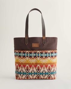 A new tote style with a cotton canvas body, leather straps and two generous front slip pockets crafted from USA-woven Pendleton wool. Cotton-lined interior has one slip pocket. Pattern placement may vary. 13"W x 14"H; 4" base. 11" handle drop. Cotton body with 100% virgin wool pockets; leather straps. Cotton lining. Wool fabric woven in our American mills. Imported of USA/imported fabric. | PASCO WOOL/LEATHER MARKET TOTE Canvas Tote Shoulder Bag With Braided Handles, Daily Use Canvas Bag With Braided Handles, Canvas Bag With Braided Handles For Daily Use, Brown Coated Canvas Tote Bag, Brown Double Handle Shoulder Bag With Canvas Lining, Canvas Bag With Braided Handles For Everyday Use, Brown Shoulder Bag With Double Handle And Canvas Lining, Fall Tote Shoulder Bag In Coated Canvas, Fall Coated Canvas Tote Shoulder Bag