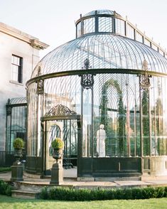 a glass house with a statue in the center