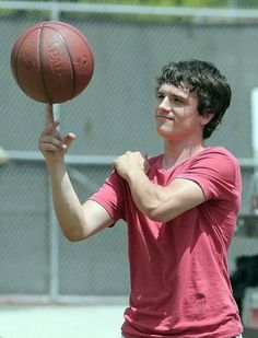 a man holding a basketball in his right hand