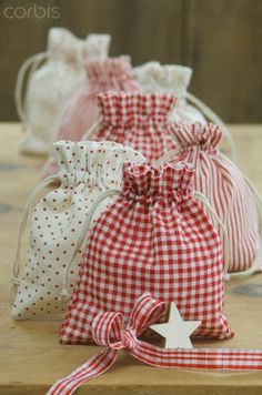 three bags with red and white gingham fabric, one has a star on it