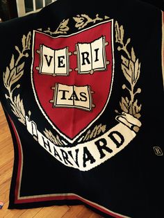 there is a black and red blanket with the words veri tas on it