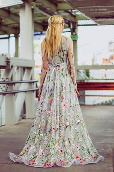 a woman with long blonde hair wearing a floral dress