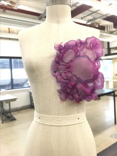 a mannequin with purple flowers on it