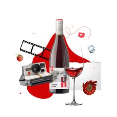 a bottle of wine, a camera and a glass of wine on a white background