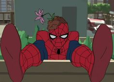 spider - man sitting on the ground with his feet up