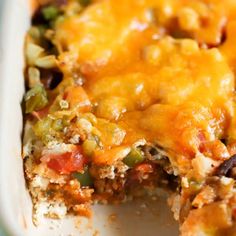 a casserole dish with meat, cheese and veggies in it on a plate