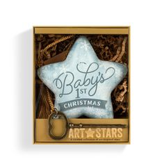 a baby's first christmas ornament in a box with a keychain