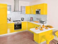 a kitchen with yellow cabinets and white counter tops is pictured in this image, there are chairs around the table