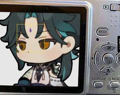 a digital camera with an anime character on it's screen and the image is being viewed