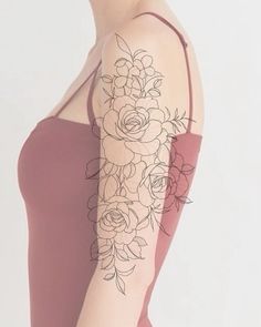 a woman's arm with flowers on it and the back of her body covered in tattoos