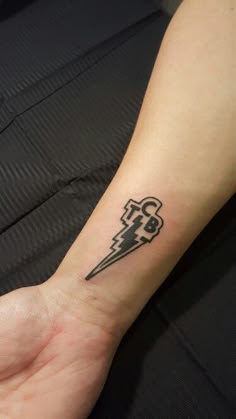 a person's arm with a tattoo on it that has an arrow in the middle