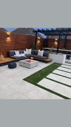 an outdoor living area with couches and fire pit