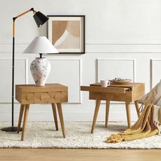 a living room with two end tables and a lamp on the table next to it