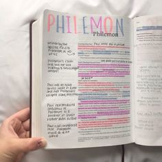 a person holding an open bible in their hand with the word philemon printed on it