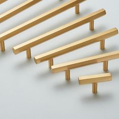 several wooden pegs are lined up on a white surface