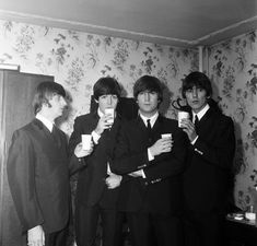 black and white photograph of the beatles drinking coffee