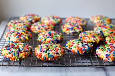 sprinkle covered cookies are cooling on a wire rack, ready to be eaten