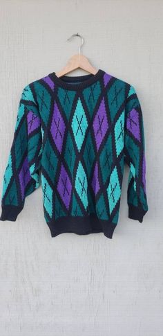 "Loving this rad sweater featuring a diamond green & purple colorblock design,  relaxed fit! Looks suuuper cute paired with leggings & your fave kicks! Great Vintage condition. Vintage circa 1990. Details: * Great Vintage condition * Vintage circa 90s  * Soft Fabric (unsure of fabric)  * Length from front: 22\" * Length from back: 24\" * Bust: 19\" * Sleeve from Shoulder: 18\"" 90s Style Purple Sweater For Fall, 90s Style Purple Fall Sweater, 90s Purple Winter Sweater, 90s Green Winter Sweater, Green 90s Style Winter Sweater, Green 90s Winter Sweater, Retro Purple Sweater For Winter, Retro Purple Winter Sweater, Diamond Girl