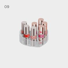 an assortment of lipsticks are displayed in a display case on a white background with the words,