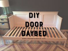 a white bed frame with the words diy door daybed on it's side