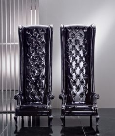 two black leather chairs sitting next to each other