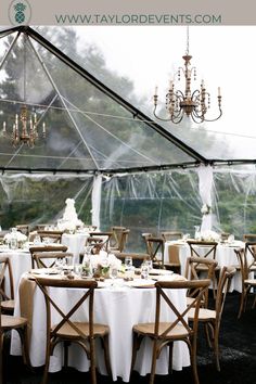 tables and chairs are set up under a tent