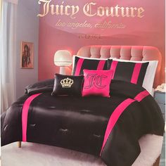 a bed with black and pink comforters in front of a sign that says juicy couture