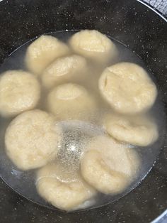 some dumplings are being cooked in a frying pan