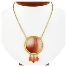 Here we have a magnificent, truly bold, and very well made Gurhan pendant necklace that was crafted in solid 24k yellow gold featuring a large round cabochon cut agate neatly bezel set at the center. This incredible stone measures approximately 32.8mm in diameter and has a truly gorgeous rich orange and white banded color and looks absolutely beautiful, thanks to its large and super attractive size. The stone is neatly bezel set in a wonderful hand hammered finish frame and is further adorned wi Art Nouveau Pendant, Silver Diamond Necklace, Ruby Pendant, Vs Diamond, Sapphire Pendant, Statement Pendant, Gold Orange, Orange Gold, How To Look Classy