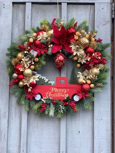 a christmas wreath hanging on the side of a wooden door