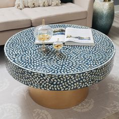 a living room with a couch, coffee table and two vases on the floor