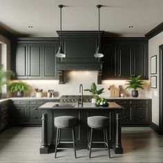 a kitchen with black cabinets and stools in front of an island that has two green plants on it