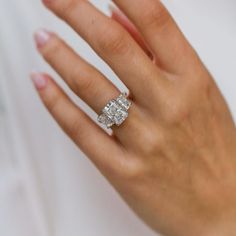 a woman's hand with a diamond ring on it