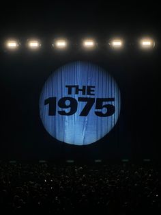 the 1970 logo is projected on stage at an event