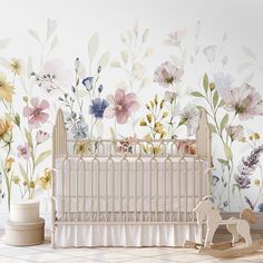 a baby's room with flowers painted on the wall