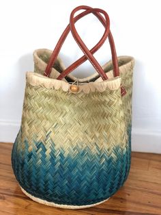 These beautiful pieces are designed in South Africa. Handmade with raffia and featuring leather handles, these bags bring the perfect mix of bohemian chic to everyday wear! Capable of being used as a handbag, basket or storage-this multi-purpose piece is a cannot miss! The double closure top provides a multi-style capability as well! Sizing: 16 inches wide x 12 inches deep x 13 inches high Bohemian Handbags, Top Handle Bags, Bohemian Chic, Leather Handles, Leather Handle, Beaded Earrings, Straw Bag, Primary Colors, South Africa