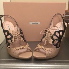 This Nude And Black Two Tone Miu Miu Lace Up Sling Back Is So Stunning! So Many Details To See And They Are Impeccable As They Are Brand New In Box And Never Worn. Luxury Leather Miu Miu Sandals, Miu Miu Slingback Heels With Heel Strap, Luxury Open Toe Sandals By Miu Miu, Elegant Miu Miu Slingback Pumps With Pointed Toe, Miu Miu Slingback Heels For Formal Occasions, Elegant Miu Miu Leather Slingback Pumps, Chic Miu Miu Open Toe Sandals, Elegant Miu Miu Slingback Pumps For Evening, Elegant Miu Miu Slingback Heels