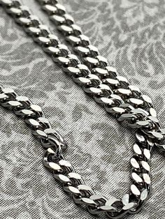 Stainless Steel Necklace - Chain Complete with Lobster Clasp - Quantity discounts -  Width of link: 2mm - Choose length and quantity (1 - 4) as desired from the drop down   - 18"   - 20"   - 24" This is a nice fluid chain.  Perfect for men who do not like to take things off and on when they shower.  A much less expensive option to a sterling silver chain for both men and women. Lead and cadmium free. Last picture shows a variety of unfinished chains offered and can be found by clicking here:  https://www.etsy.com/shop/ClassicElements?ref=seller-platform-mcnav§ion_id=20741978 Thanks for shopping by today! Mark us as a favorite so you can find us easily next time you shop! Stainless Steel Chain Jewelry For Father's Day, Silver Curb Chain Jewelry For Father's Day, Father's Day Silver Curb Chain Jewelry, Neck Chain, Men's Necklace, Steel Necklace, 1 Or 2, Stainless Steel Necklace, Steel Chain