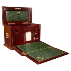 an old wooden box with two drawers and a tennis court in the bottom drawer on top