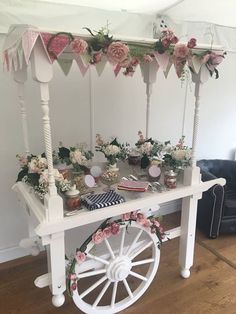 a white cart with flowers and bunting on it