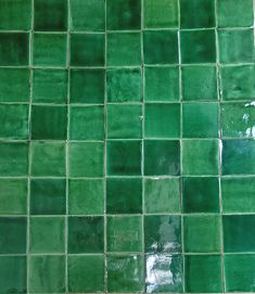 a green tiled wall with no one in it