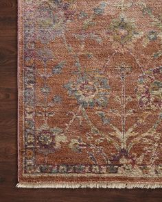 an orange rug on a wooden floor