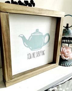 there is a teapot with the words you are everything on it in a wooden frame