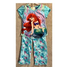 Dress Your Little Princess In This Adorable Two-Piece Pajama Set Featuring Disney's Ariel. The Pajama Set Is Designed For Girls And Comes In A Size Small. It Includes A Top And A Bottom That Are Both Multicolored, Featuring Various Disney Princesses, Including Ariel. The Set Is Brand New And Perfect For Your Little Girl's Bedtime. The Pajama Set Is Made Of High-Quality Materials That Are Soft And Comfortable To Sleep In. The Character Family Of The Pajama Set Is Disney Princess, Making It An Exc Disney Pajamas, Disney Princess Ariel, Princess Ariel, Disney Ariel, Disney Princesses, Kids Pajamas, Little Princess, Disney Movies, To Sleep