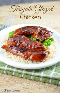 teriyaki glazed chicken with rice and peas on a plate