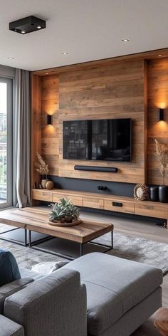 a living room filled with furniture and a flat screen tv mounted to the wall above it