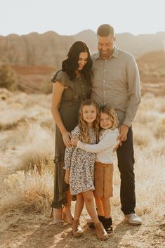 a family posing for a photo in the desert