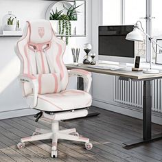 a white and pink office chair sitting in front of a desk with a computer on it