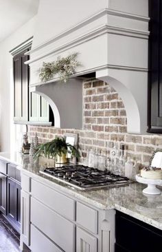 a kitchen with an oven, stove and counter tops covered in christmas greener decorations